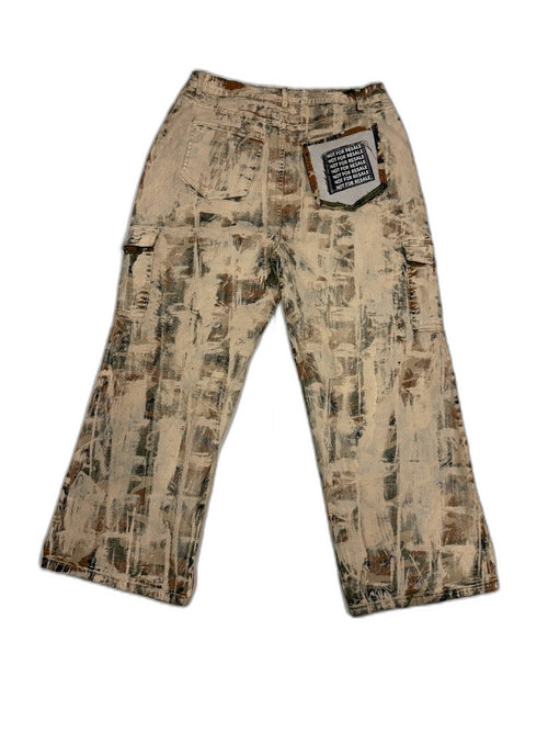 Back of bleached desert camo cargo pants showing NFR repeating text patch on back pocket — one of one custom reworked Not For Resale LA