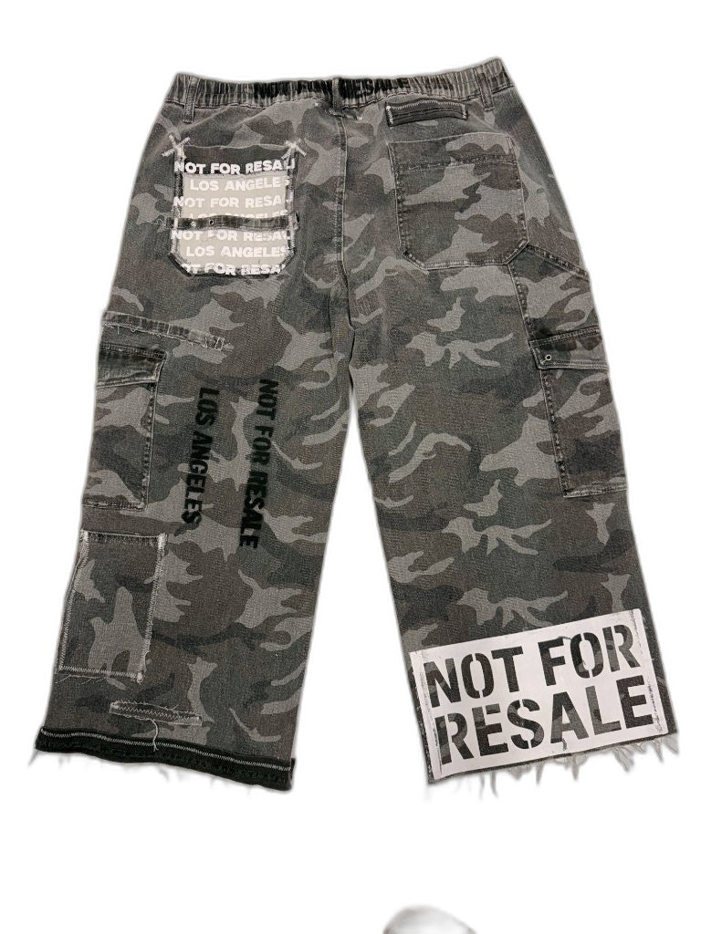 Back of grey urban camo cargo pants showing NOT FOR RESALE LOS ANGELES black stencil and NFR repeating text patch — one of one upcycled reconstructed Not For Resale LA