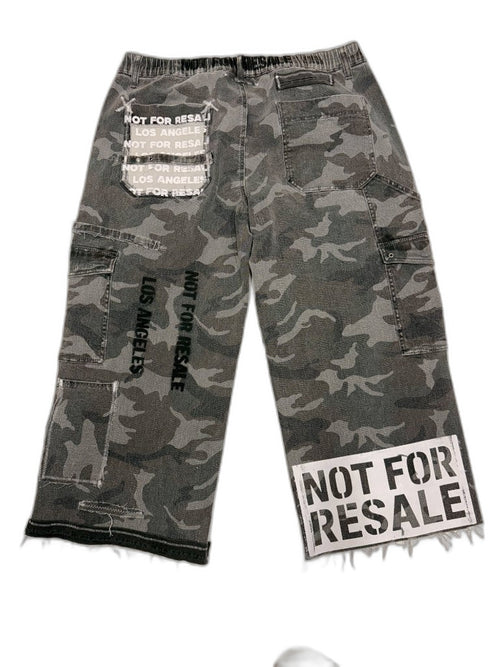 Back of grey urban camo cargo pants showing NOT FOR RESALE LOS ANGELES black stencil and NFR repeating text patch — one of one upcycled reconstructed Not For Resale LA
