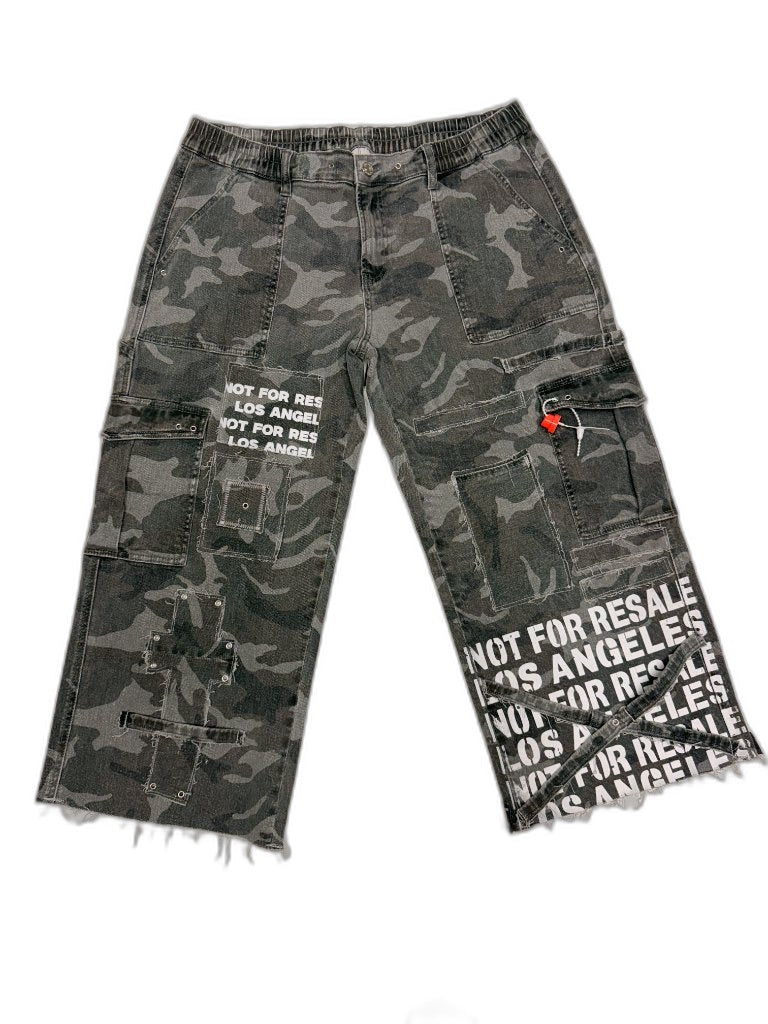 Front of grey urban camo multi-pocket cargo pants with NOT FOR RESALE LOS ANGELES stencil repeating across right hem and NFR text patch on left thigh — one of one reconstructed upcycled streetwear Los Angeles
