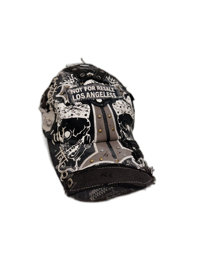 Front of black skull all-over print reconstructed cap with NOT FOR RESALE LOS ANGELES embroidered patch gold brass studs and grey stripe bill — one of one NFR LA