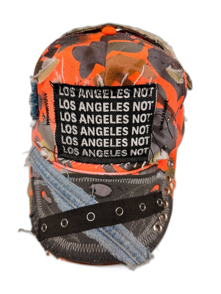 Front of orange blaze camo reconstructed cap with LOS ANGELES NOT FOR RESALE woven text patch denim diagonal bill strip and black grommet strap — one of one NFR LA