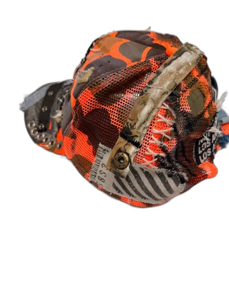 Opposite side of orange camo cap showing black fabric panel with studs mesh layering and NFR text — one of one upcycled NFR LA streetwear
