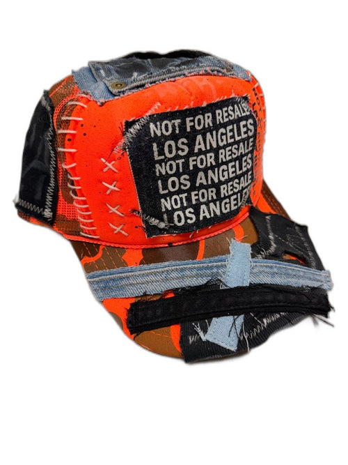 Front of orange camo cap with blue denim crown patch white X cross-lace stitching NOT FOR RESALE LOS ANGELES woven patch and reconstructed denim bill strips — one of one NFR LA