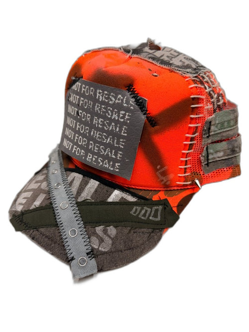 Front of orange spray-dyed reconstructed cap with NOT FOR RESALE stencil patch white ladder stitch lacing NFR print bill X webbing strap and metal spike — one of one NFR LA