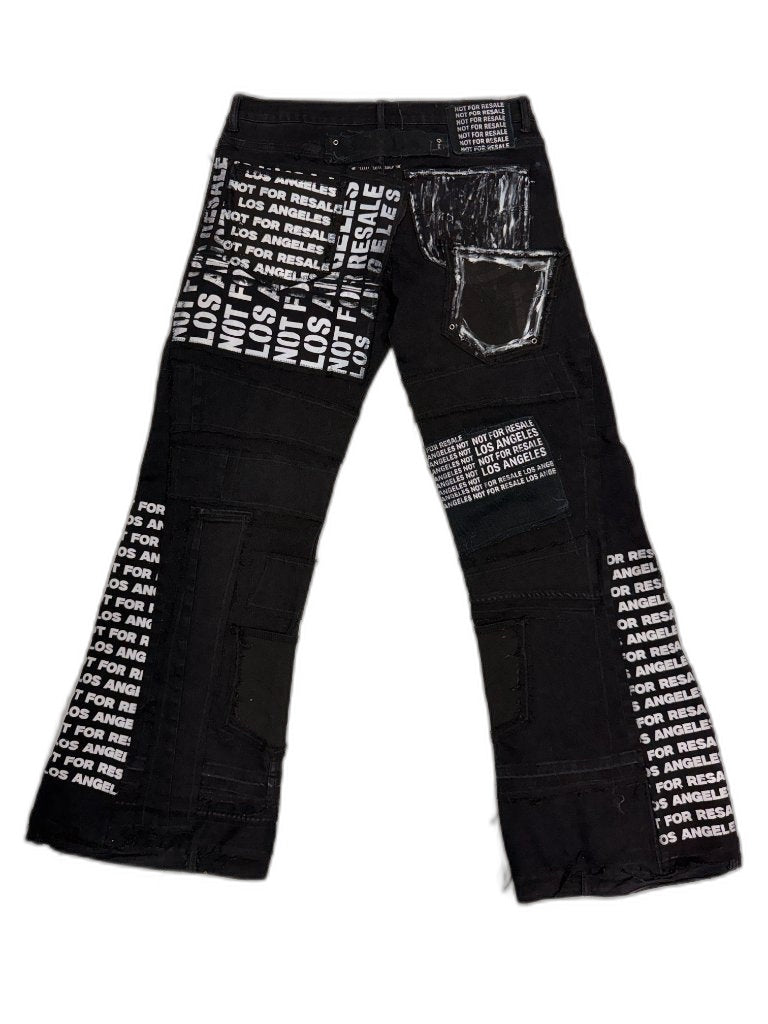 Back full view of black reconstructed flare denim showing all-over NFR LOS ANGELES screen print panels hand painted pocket outline white graphic grommet and NFR waist patch — one of one reconstructed Not For Resale
